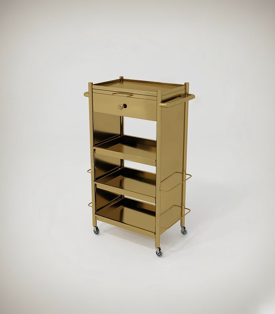 A gold-colored metal salon trolley with multiple compartments and wheels for mobility.