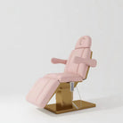 Pink leather electric beauty bed with gold base and hand control