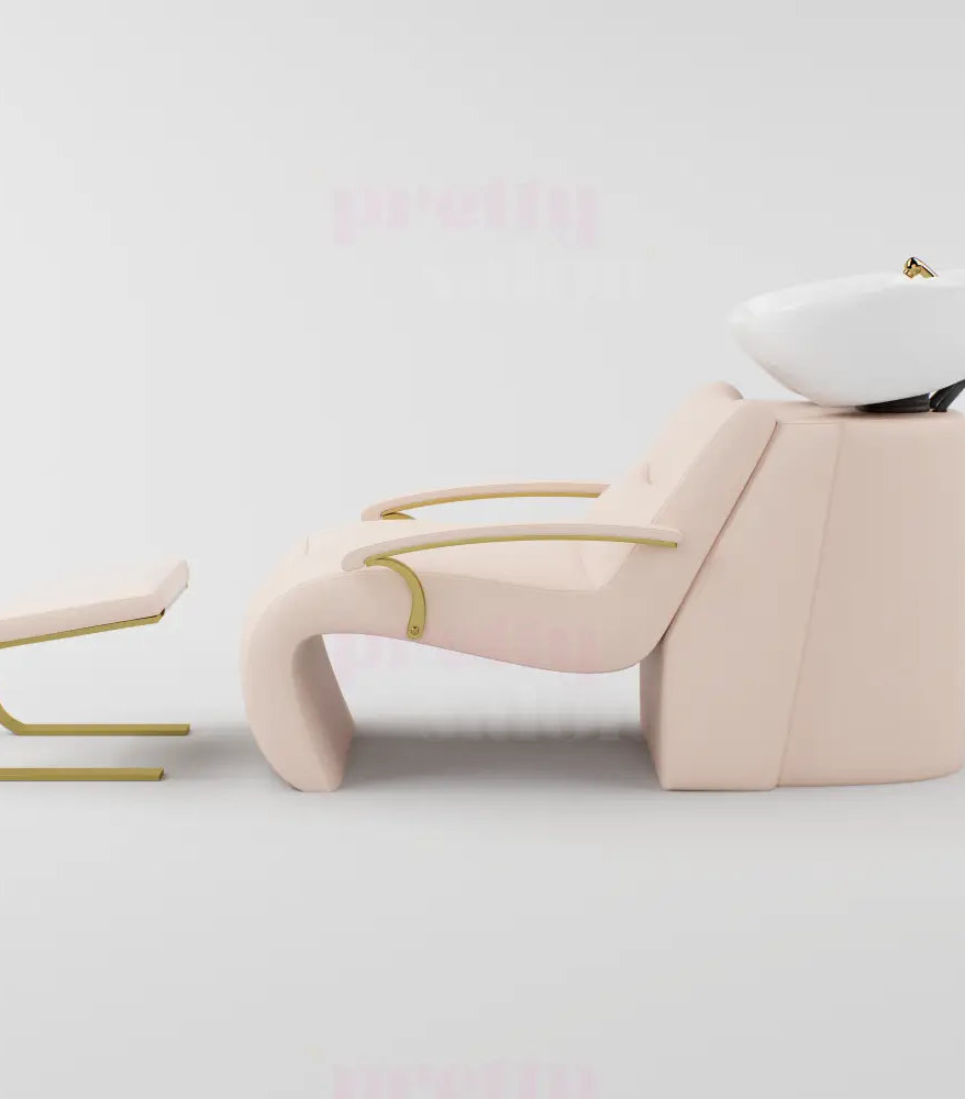 Pink and gold shampoo chair with footrest and gold accessories