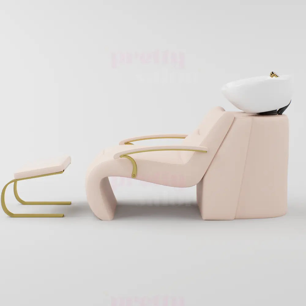 Pink and gold shampoo chair with footrest and gold accessories