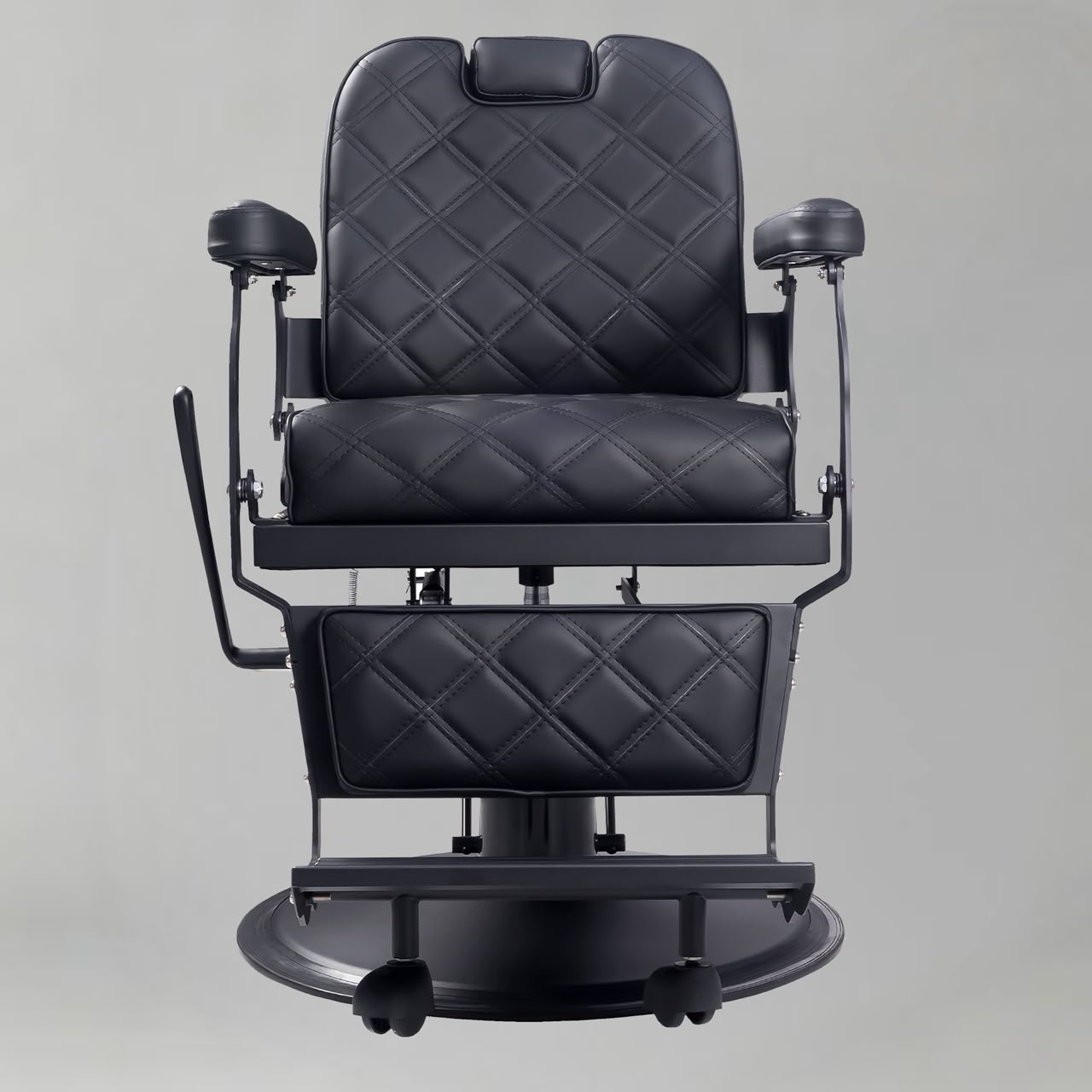 Professional black barber chair with padded armrests, footrest and heavy-duty hydraulic pump, ideal for modern UK barbershops and salons.