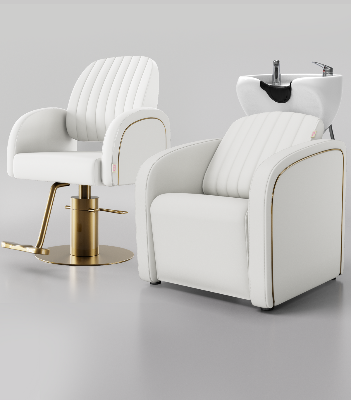 Two modern salon chairs in white faux leather with gold trim and gold bases, one with a matching white hair wash sink attachment.