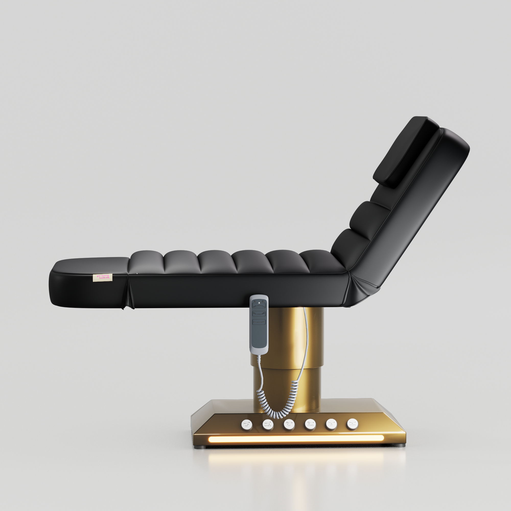 Black adjustable beauty bed with gold base and integrated foot control system