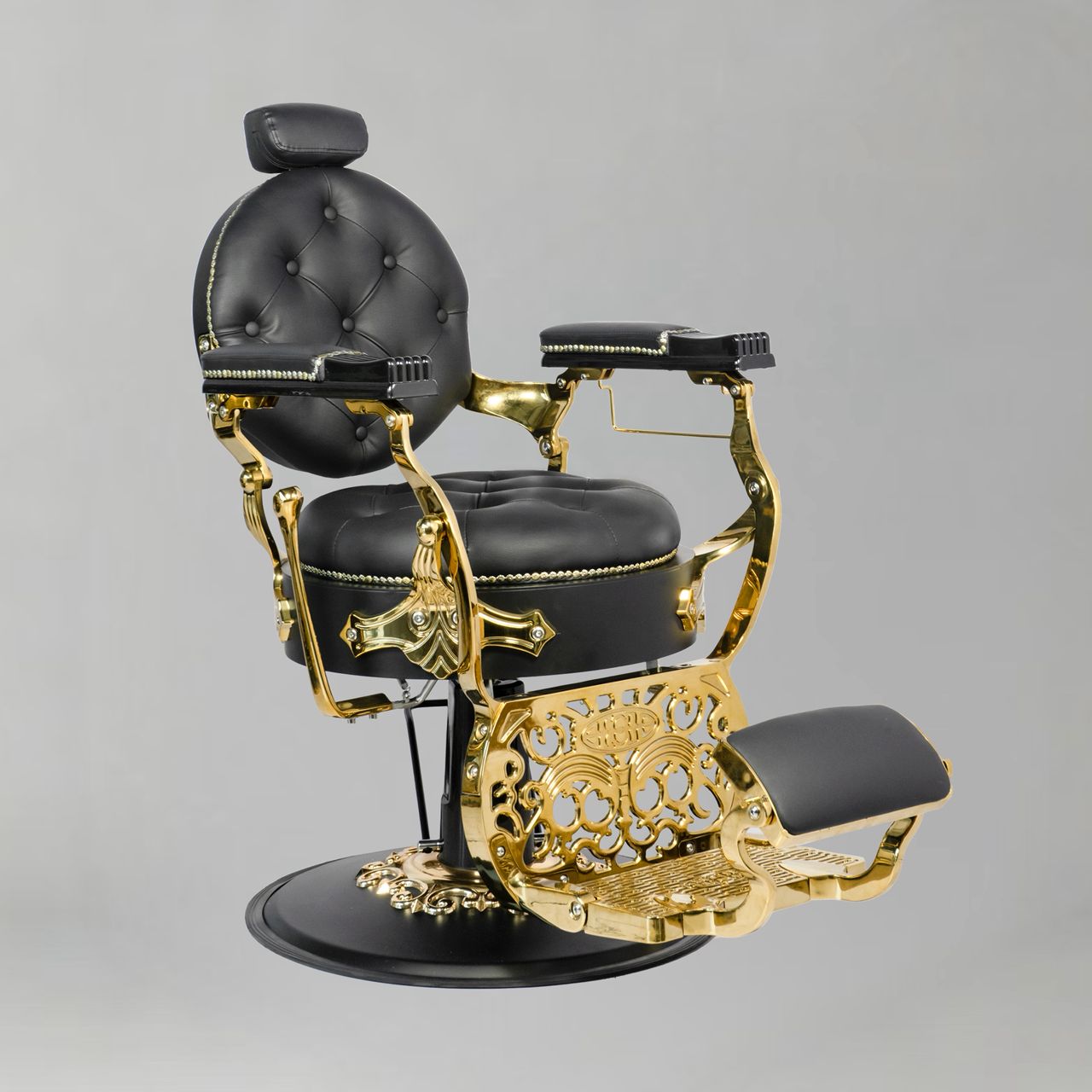 vintage barbershop chair with circular back and gold leg rest