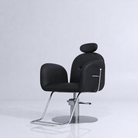 Black leather styling chair with silver footrest that reclines