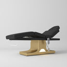 Black electric beauty bed with a gold base