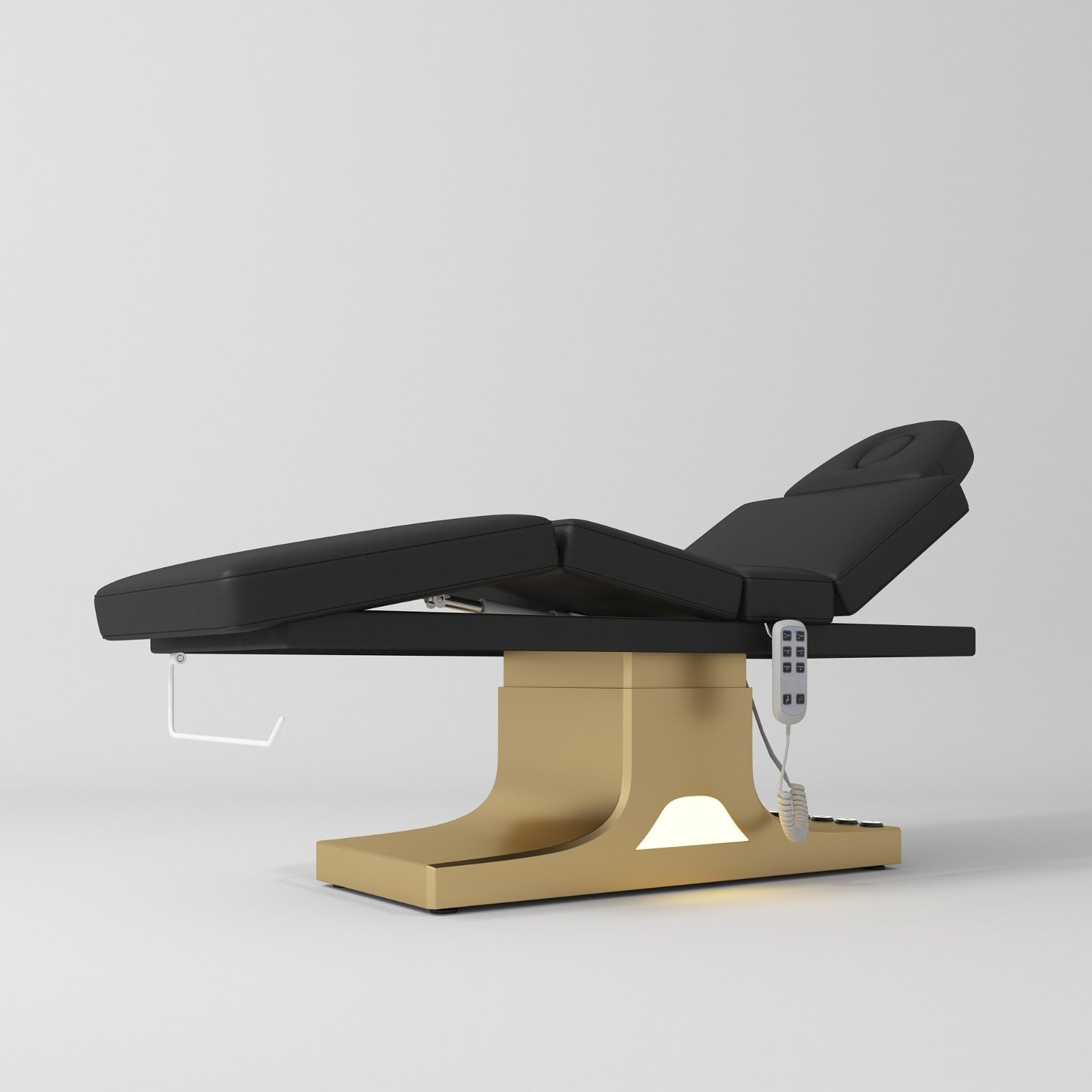 Black electric beauty bed with a gold base