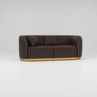 Salon waiting area sofa in brown leather and gold trim