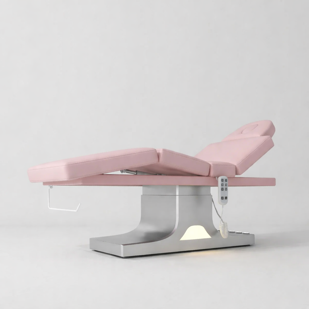 Bed used for laying down treatments in pink leather and stainless steel base