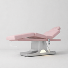 Bed used for laying down treatments in pink leather and stainless steel base