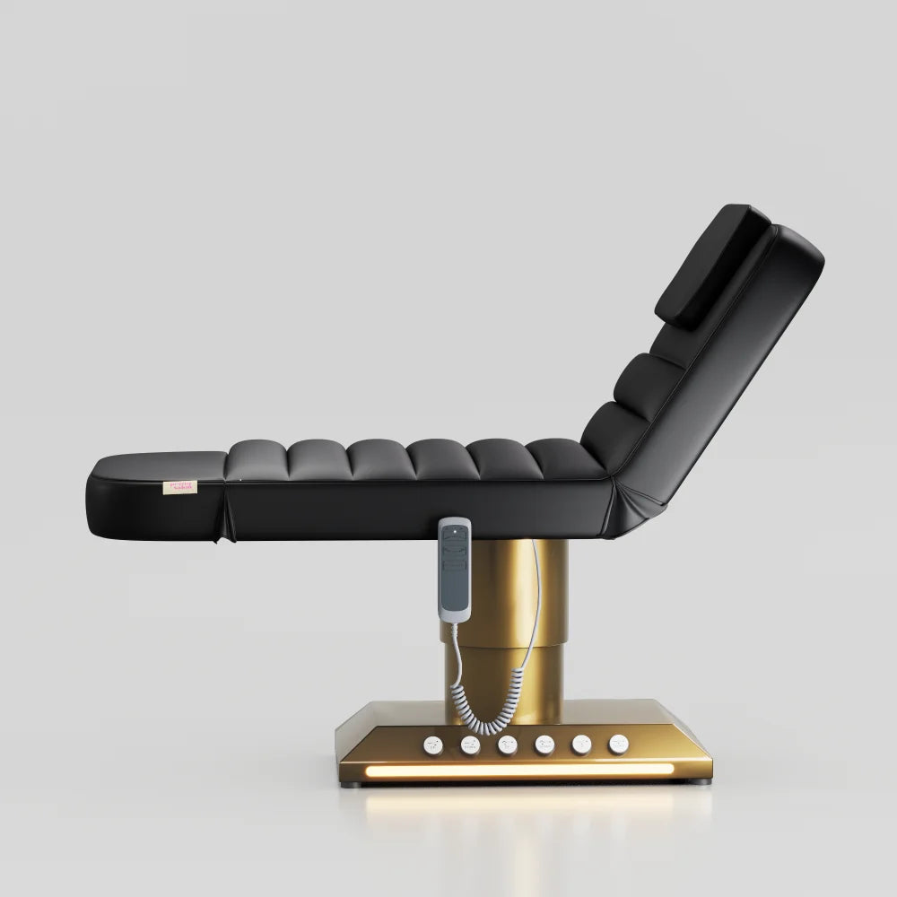 Black adjustable beauty bed with gold base and integrated foot control system