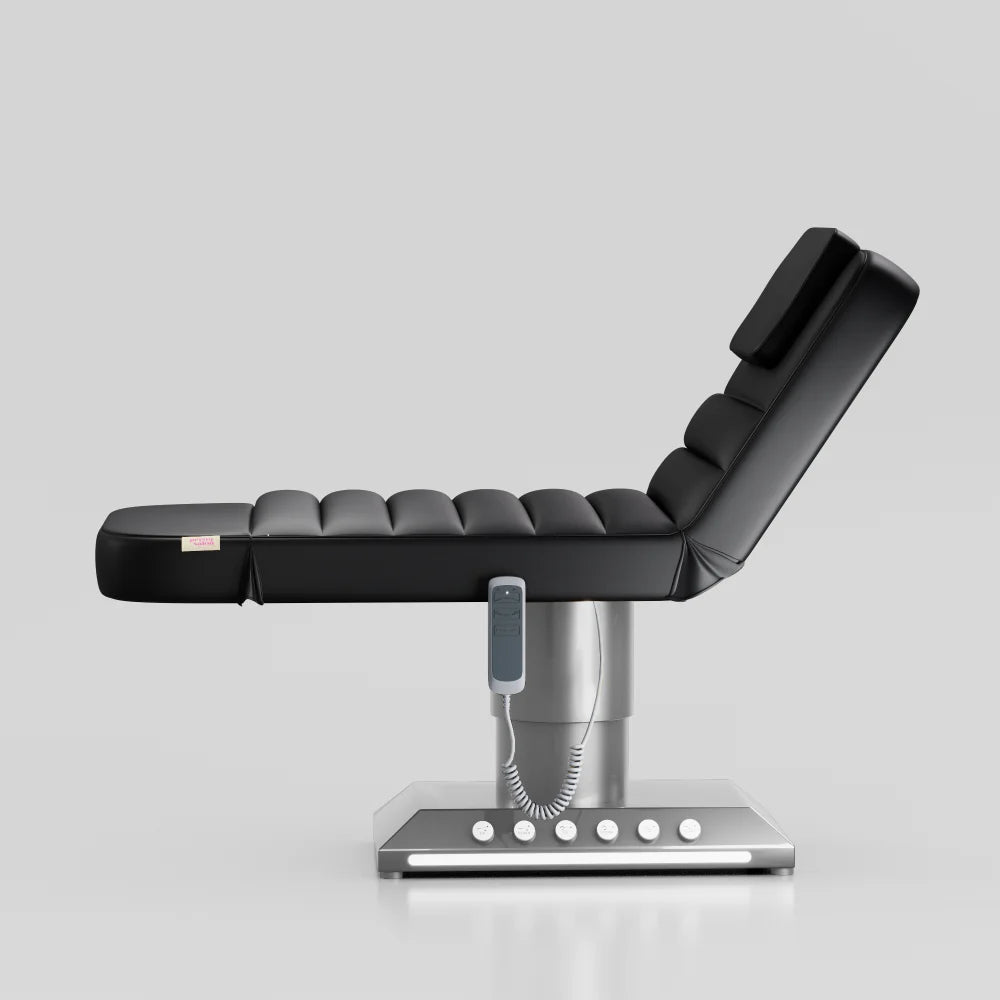 Black adjustable beauty bed with silver base and integrated foot control system