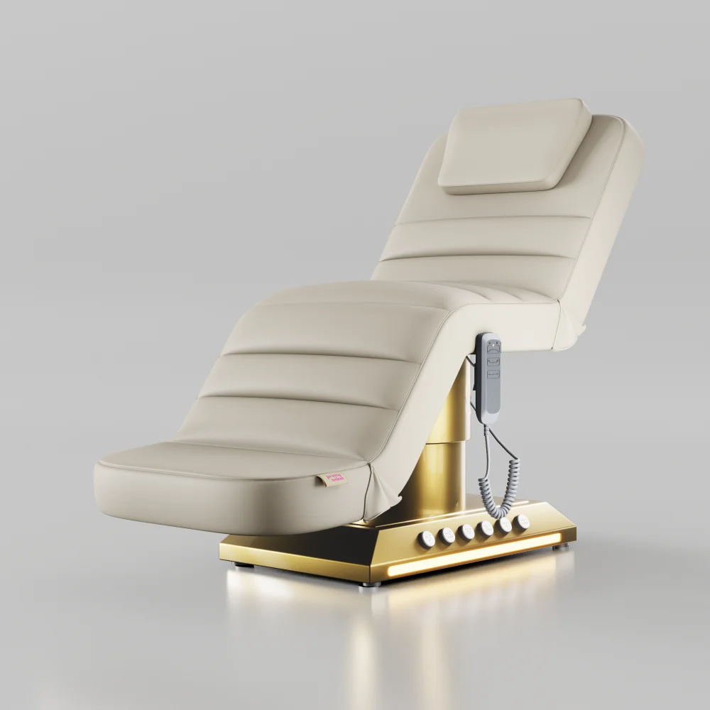 Cream electric treatment bed with gold base and foot control for beauty treatments