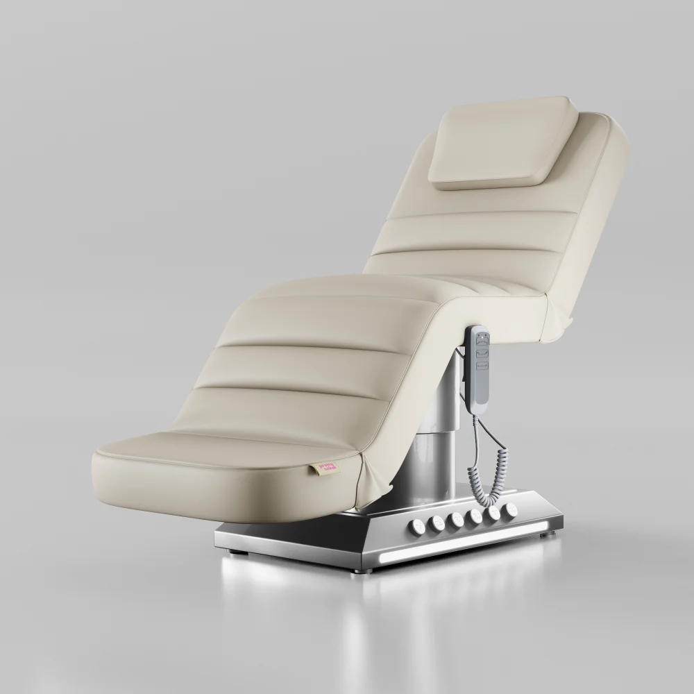 Cream electric treatment bed with silver base and foot control for beauty treatments