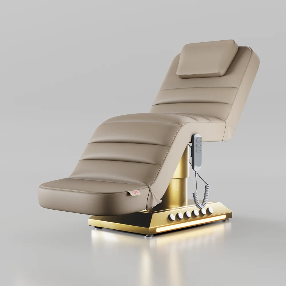 Nude adjustable beauty bed with gold base and foot pedal controls for salons and clinics