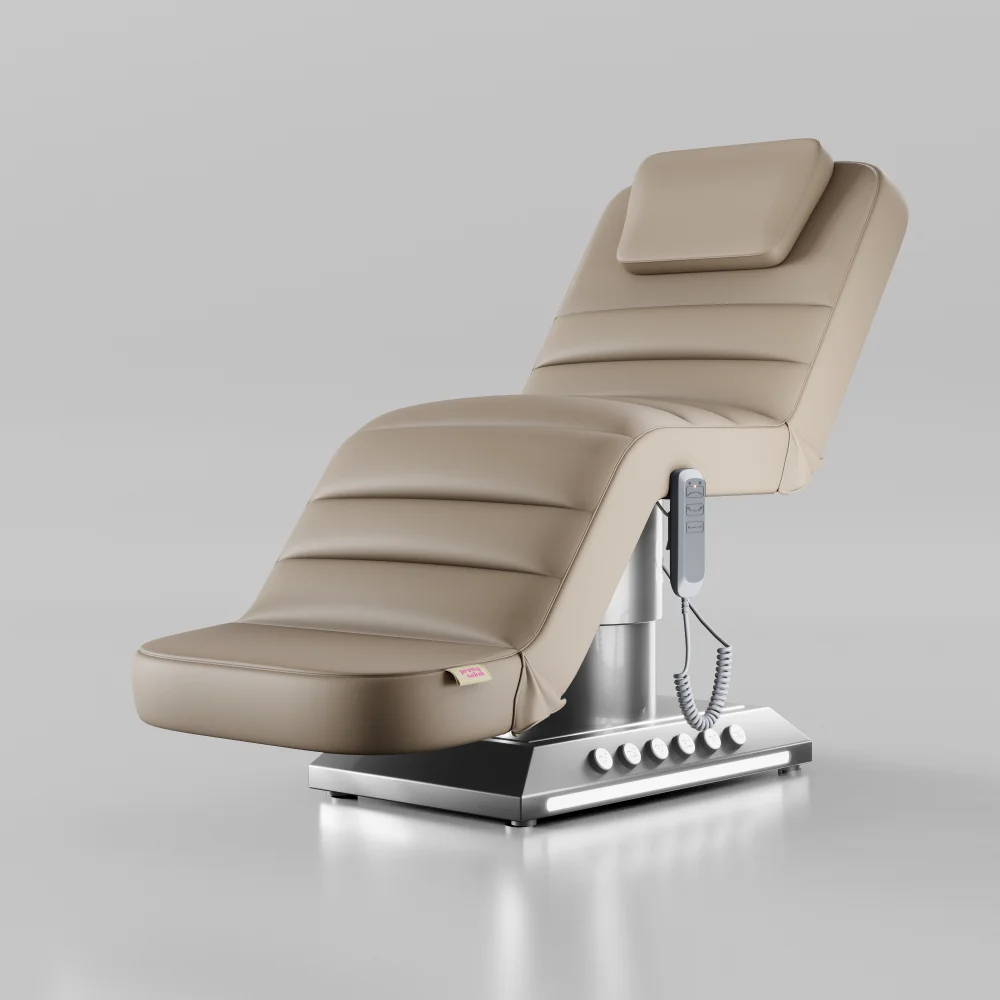 Nude adjustable beauty bed with silver base and foot pedal controls for salons and clinics
