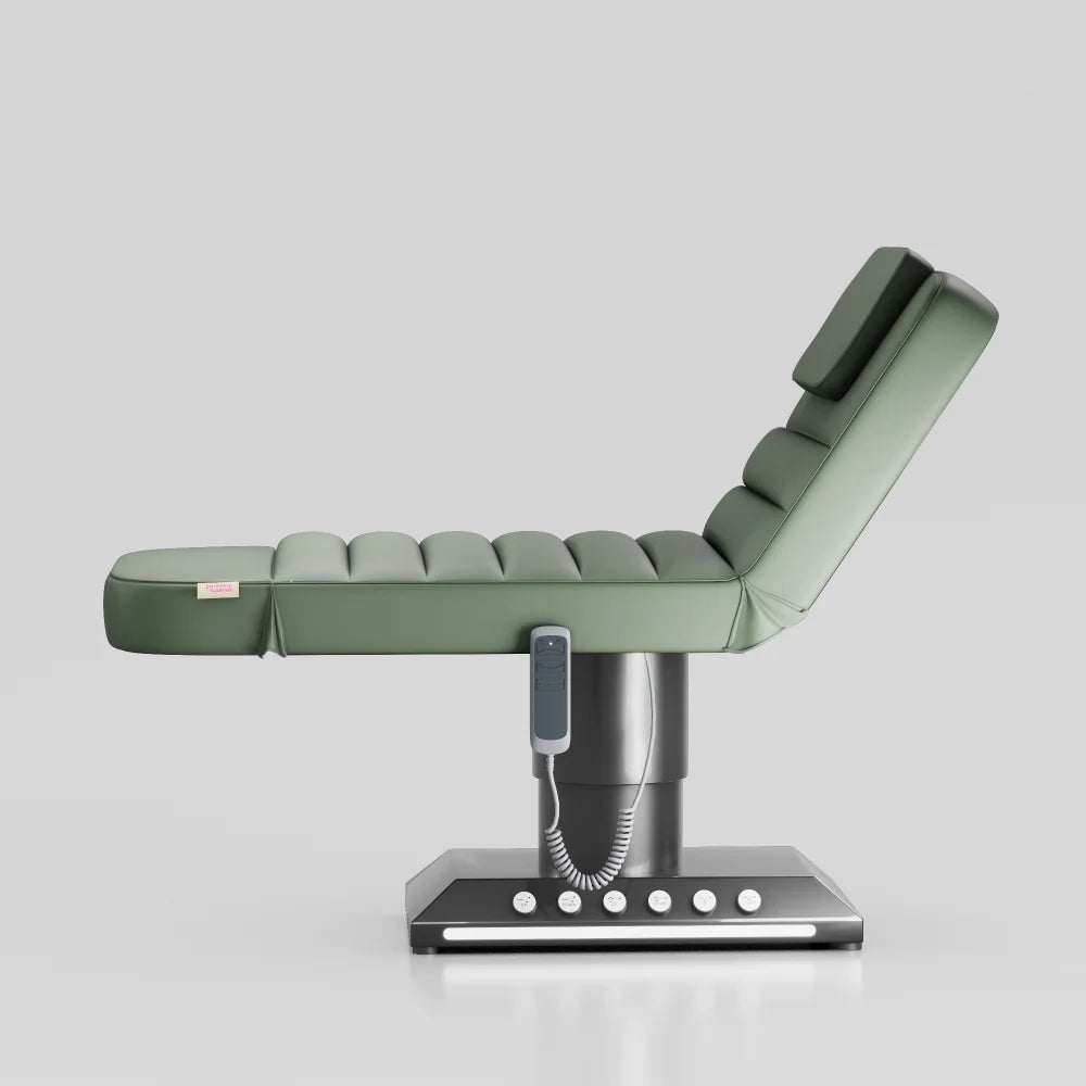 Sage green adjustable beauty bed with chrome black base and built in foot control for treatments