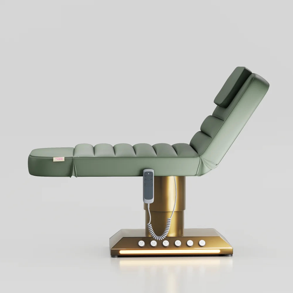 Sage green adjustable beauty bed with gold base and built in foot control for treatments