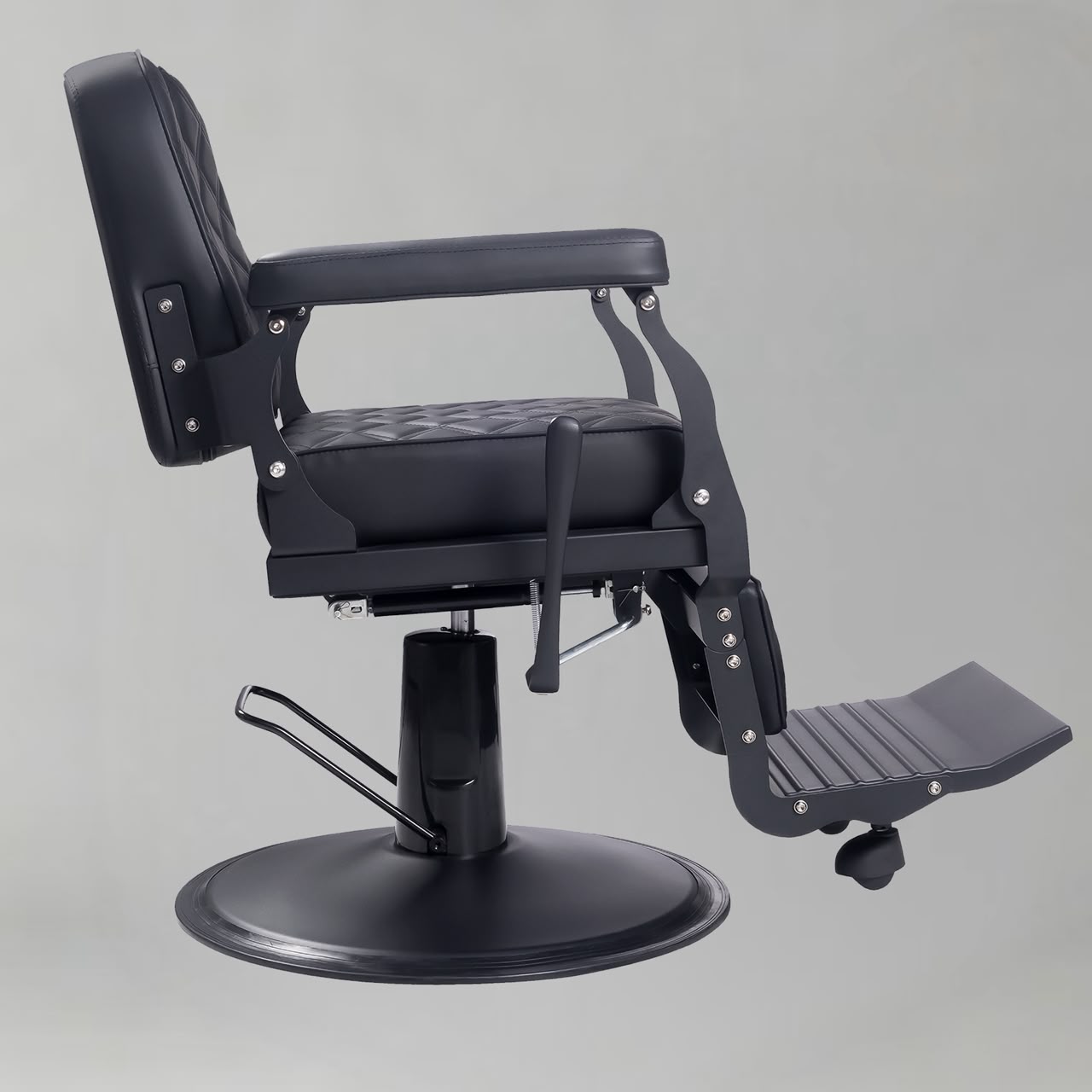 The Tonella Barber Chair in black with quilted upholstery, reclining backrest, adjustable headrest and hydraulic base for professional barbershops.