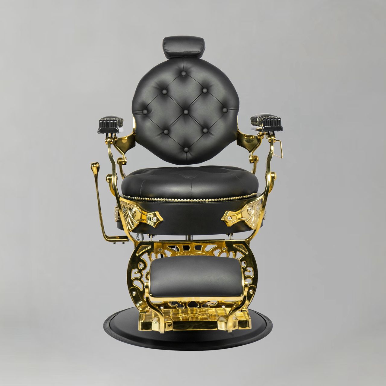 Barber Chair in black and gold with a heavy-duty hydraulic base, reclining backrest, adjustable headrest and ornate vintage detailing, shown from a front angled view.