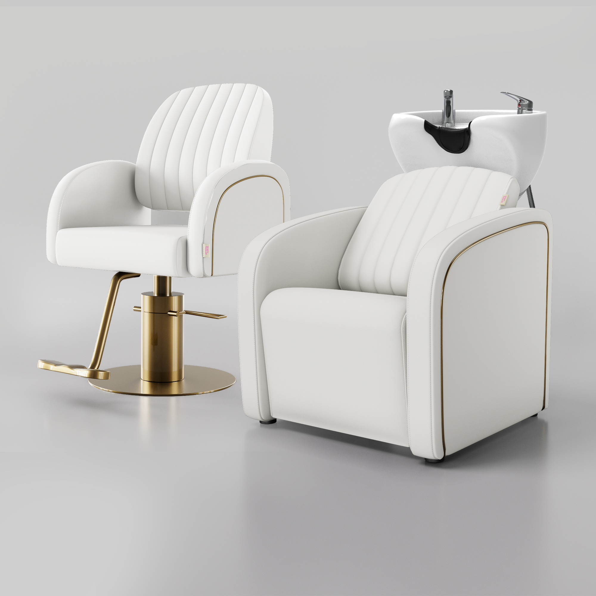Two modern salon chairs in white faux leather with gold trim and gold bases, one with a matching white hair wash sink attachment.